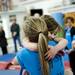 Faith Falzon (right) embraces Amelia Moorehouse after a surprise gift from the level nine team at Gym America on Monday, January 28. Daniel Brenner I AnnArbor.com